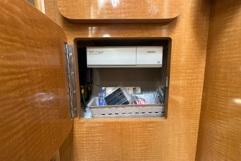Slide: The Image of Wooden cabinet interior with Clarion stereo system in a 2008 Larson Cabrio 260 boat. - 47