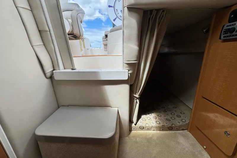 Slide: The Image of Interior of a 2008 Larson Cabrio 260 boat, featuring seating and cabin entrance. - 48