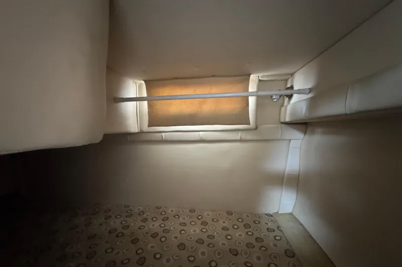 Slide: The Image of Interior cabin of 2008 Larson Cabrio 260 boat with beige upholstery. - 52