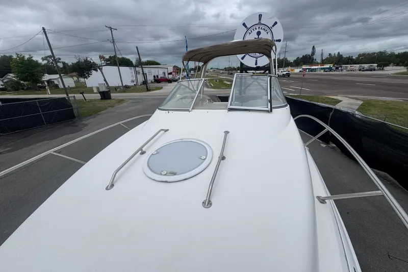 Slide: The Image of 2008 Larson Cabrio 260 boat on display, overcast sky, street view background. - 57