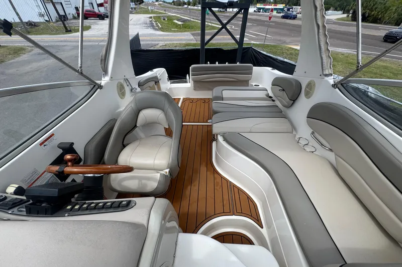 Slide: The Image of 2008 Larson Cabrio 260 boat interior with plush seating and wooden flooring. - 58