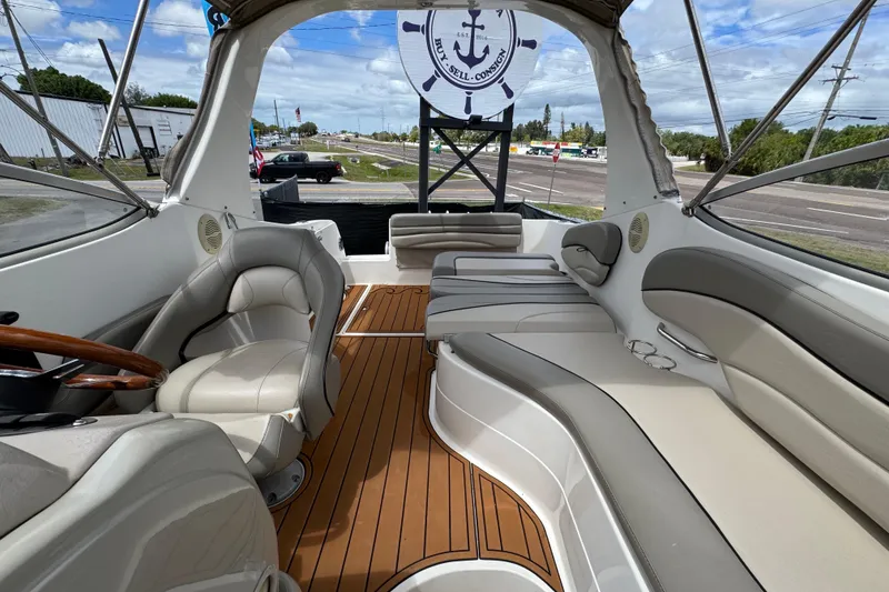 Slide: The Image of Interior of a 2008 Larson Cabrio 260 boat with beige seating and wood flooring. - 59