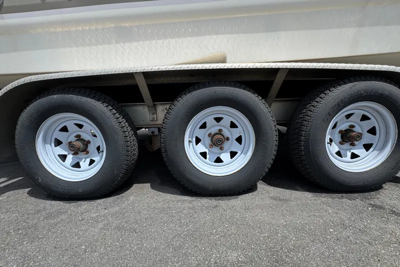 Slide: The Image of Triple axle trailer with white wheels for 2008 Larson Cabrio 260 boat. - 65