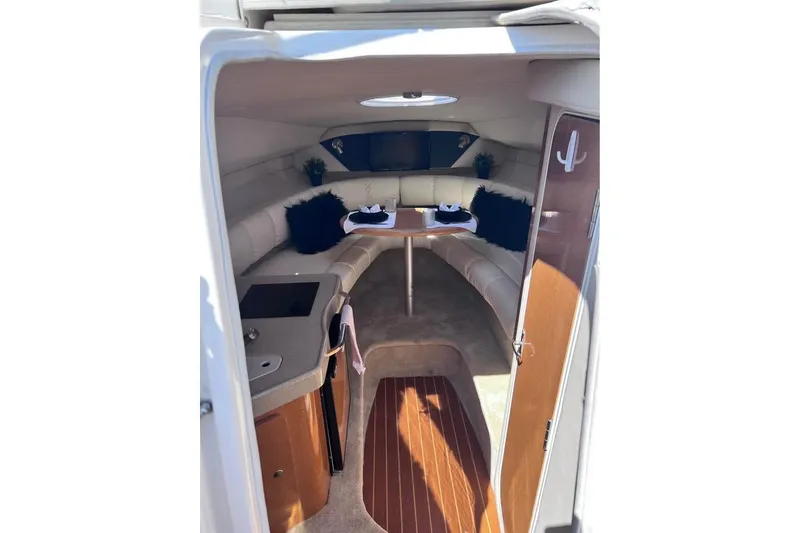 Slide: The Image of Interior of 2008 Larson Cabrio 260 boat with cozy seating and wooden accents. - 8