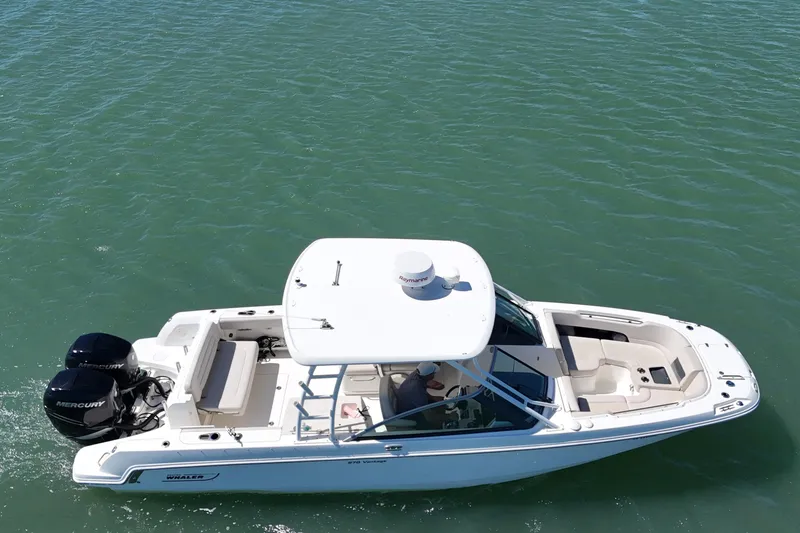Slide: The Image of 2017 Boston Whaler 270 Vantage boat cruising on clear blue water. - 12