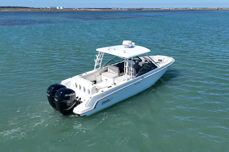 Slide: The Image of 2017 Boston Whaler 270 Vantage boat cruising on clear blue water. - 13