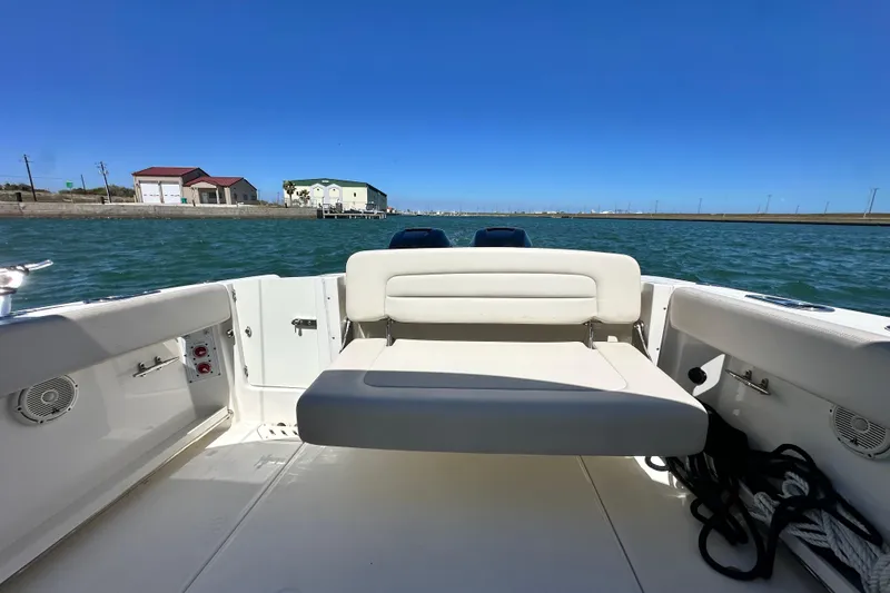 Slide: The Image of 2017 Boston Whaler 270 Vantage boat interior with seating, on calm water. - 18