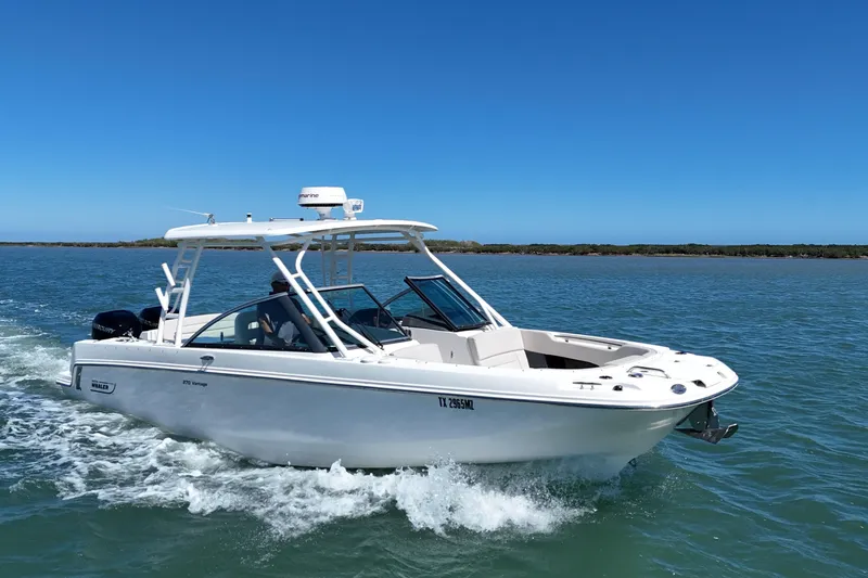 Slide: The Image of 2017 Boston Whaler 270 Vantage cruising on clear blue waters under a sunny sky. - 2