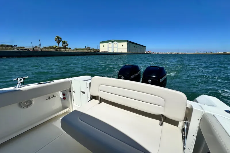 Slide: The Image of 2017 Boston Whaler 270 Vantage boat on water, featuring dual engines and spacious seating. - 20