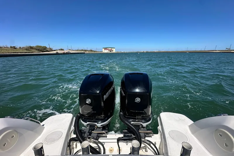 Slide: The Image of 2017 Boston Whaler 270 Vantage with dual Mercury outboard engines on open water. - 21