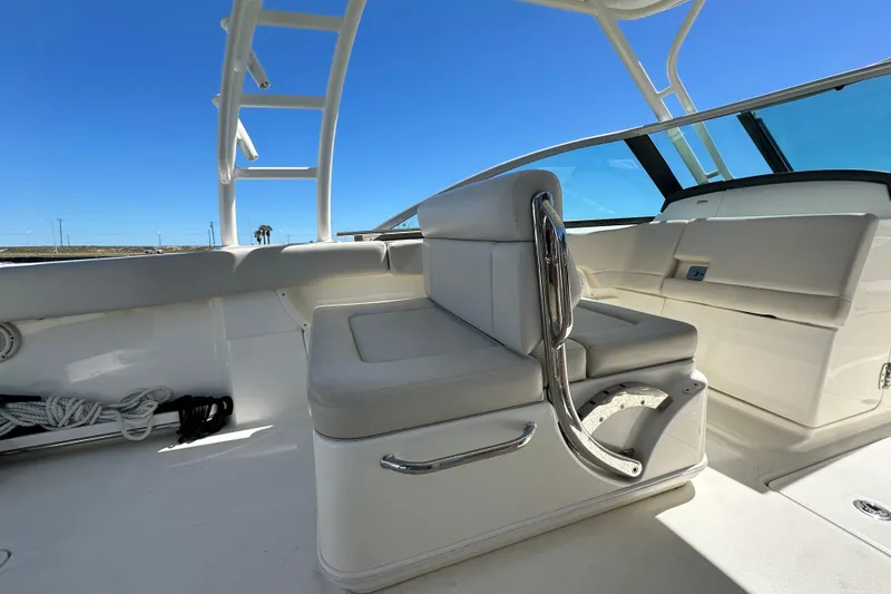 Slide: The Image of 2017 Boston Whaler 270 Vantage interior with seating and clear blue sky background. - 23