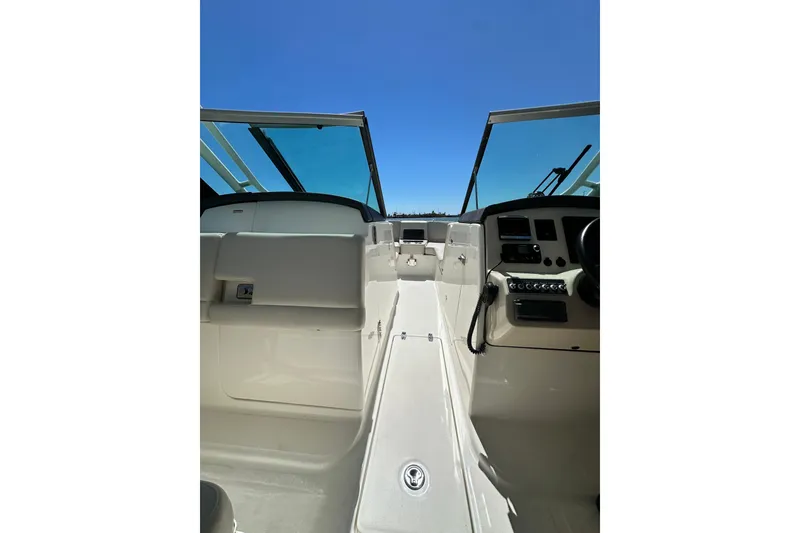 Slide: The Image of 2017 Boston Whaler 270 Vantage boat interior with open windshield and clear blue sky. - 25