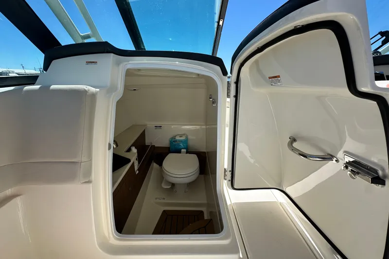 Slide: The Image of 2017 Boston Whaler 270 Vantage boat interior with compact marine toilet. - 28