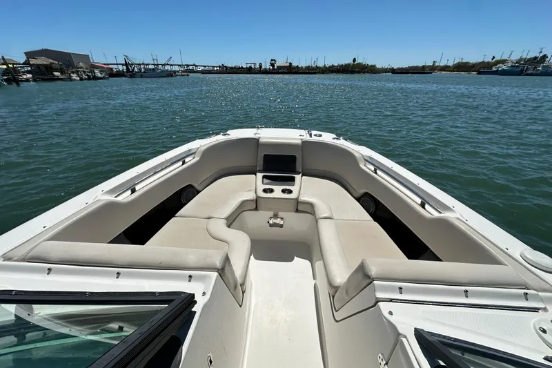 Slide: The Image of 2017 Boston Whaler 270 Vantage boat interior with seating, on calm water. - 31