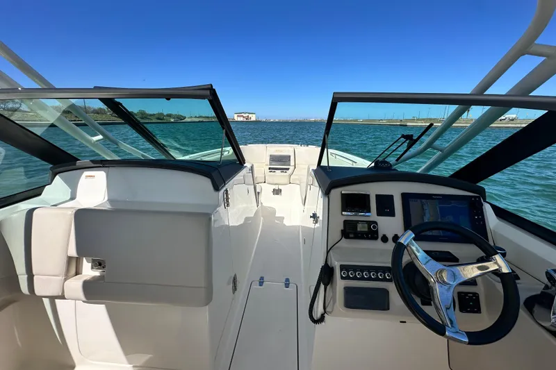 Slide: The Image of 2017 Boston Whaler 270 Vantage boat interior with steering wheel and navigation system. - 33