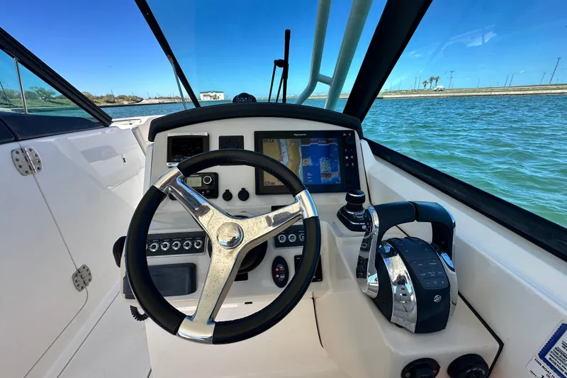 Slide: The Image of Cockpit view of 2017 Boston Whaler 270 Vantage boat with steering wheel and navigation system. - 34