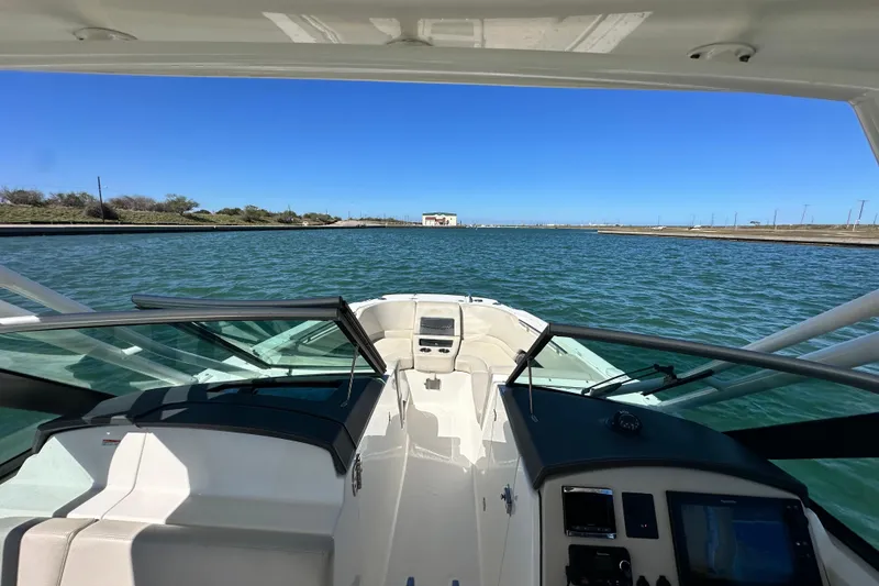 Slide: The Image of 2017 Boston Whaler 270 Vantage navigating calm waters under clear blue skies. - 39