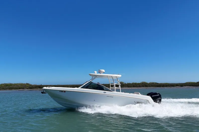 Slide: The Image of 2017 Boston Whaler 270 Vantage cruising on clear blue water under a sunny sky. - 4