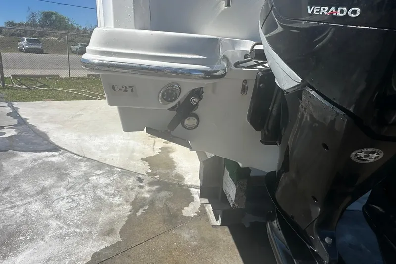 Slide: The Image of 2017 Boston Whaler 270 Vantage boat with Verado engine, docked on concrete surface. - 49