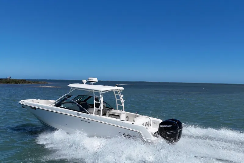 Slide: The Image of 2017 Boston Whaler 270 Vantage cruising on open water under clear blue skies. - 5