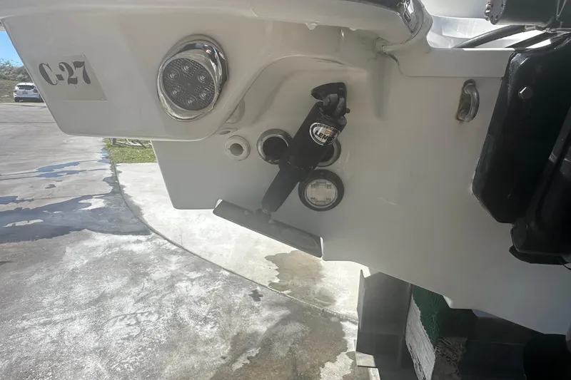 Slide: The Image of Rear view of a 2017 Boston Whaler 270 Vantage boat with trim tabs and lights. - 51