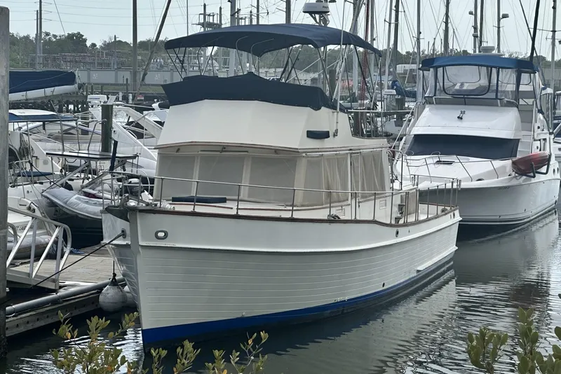 The Image of 1979 Grand Banks 42 Classic yacht docked at a marina, surrounded by other boats. - 0