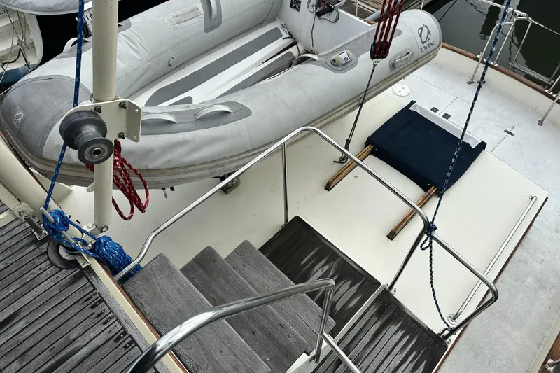 Slide: The Image of 1979 Grand Banks 42 Classic yacht deck with inflatable dinghy and wooden steps. - 10