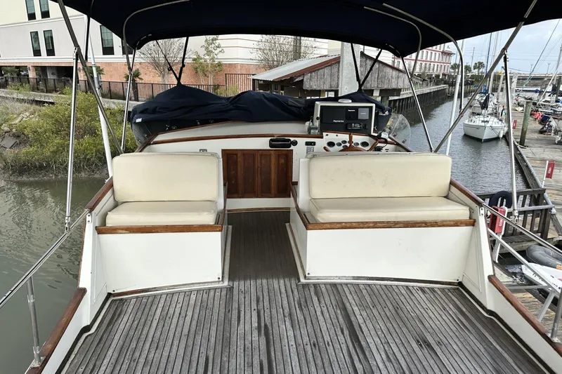 Slide: The Image of 1979 Grand Banks 42 Classic yacht deck with seating and navigation equipment. - 14