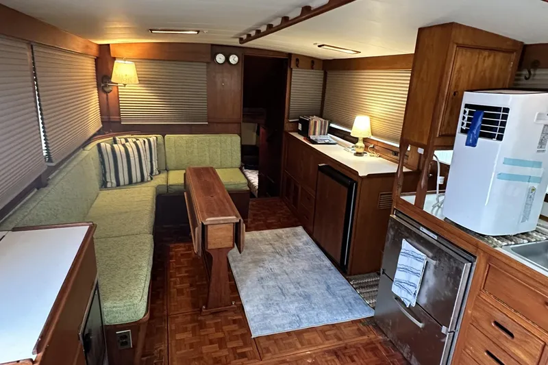 Slide: The Image of Interior of a 1979 Grand Banks 42 Classic yacht with cozy seating and wooden cabinetry. - 17