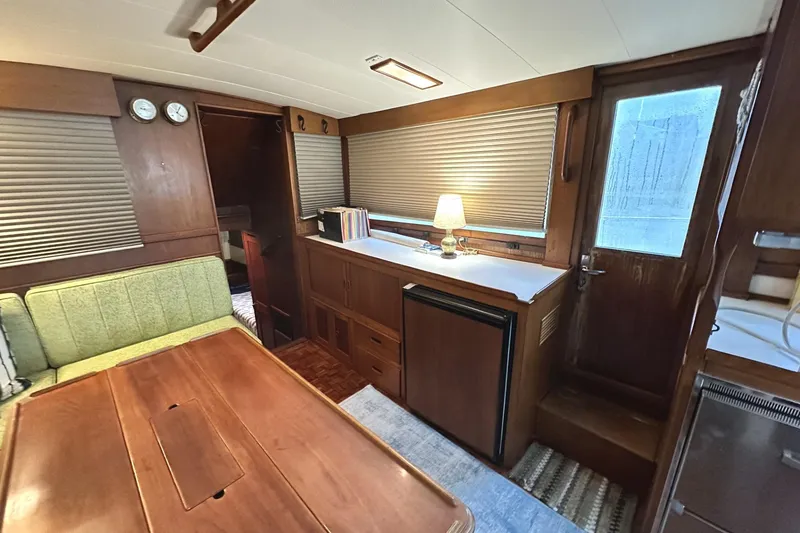 Slide: The Image of Interior of a 1979 Grand Banks 42 Classic yacht with wood finishes and cozy seating. - 21