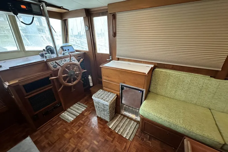 Slide: The Image of Interior of 1979 Grand Banks 42 Classic yacht with helm, seating, and wooden accents. - 22