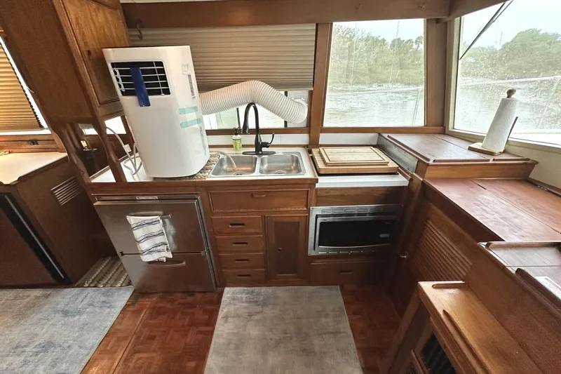 Slide: The Image of 1979 Grand Banks 42 Classic yacht kitchen with wood cabinetry and modern appliances. - 27