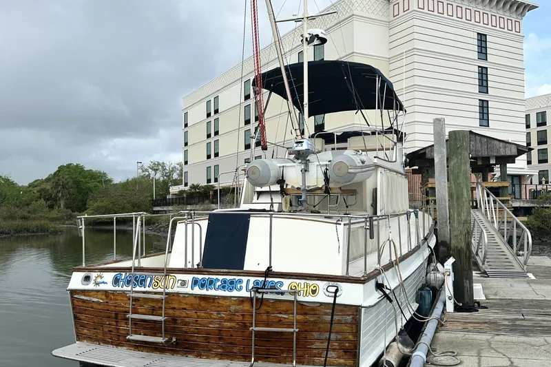 Slide: The Image of 1979 Grand Banks 42 Classic yacht docked near a modern building. - 3