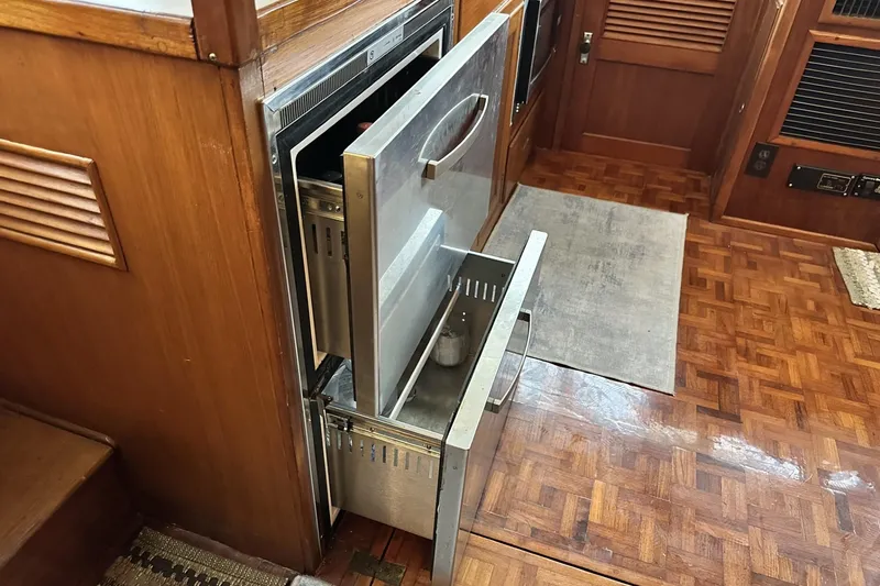 Slide: The Image of 1979 Grand Banks 42 Classic interior with open stainless steel drawers and wood flooring. - 31