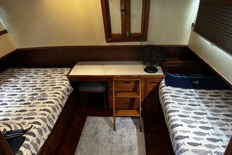 Slide: The Image of 1979 Grand Banks 42 Classic cabin with twin beds and wooden furnishings. - 34