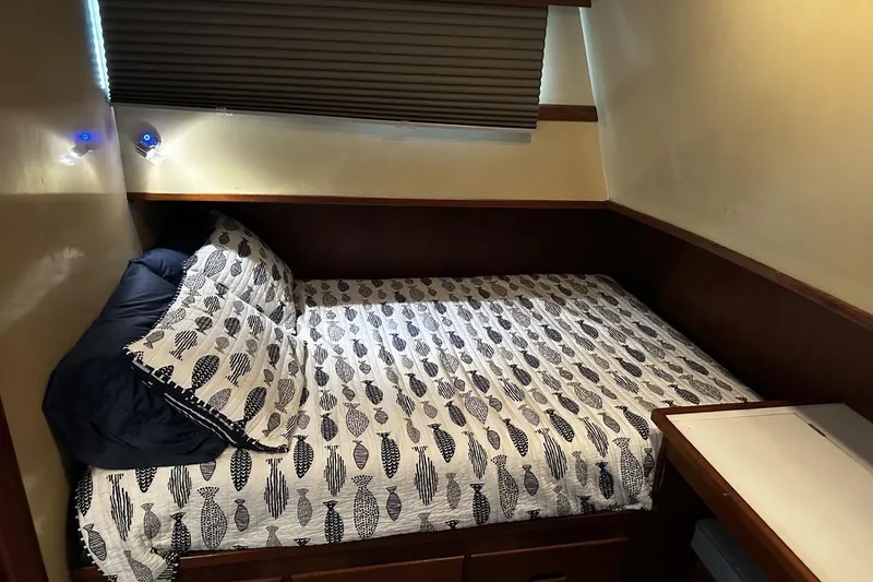 Slide: The Image of Cozy cabin bed in 1979 Grand Banks 42 Classic yacht with patterned bedding. - 35