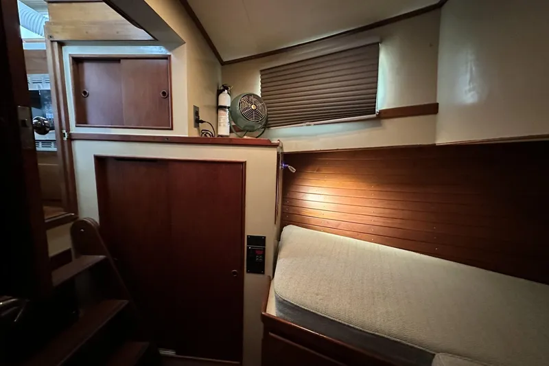 Slide: The Image of Cozy cabin interior of 1979 Grand Banks 42 Classic yacht with wooden paneling. - 41