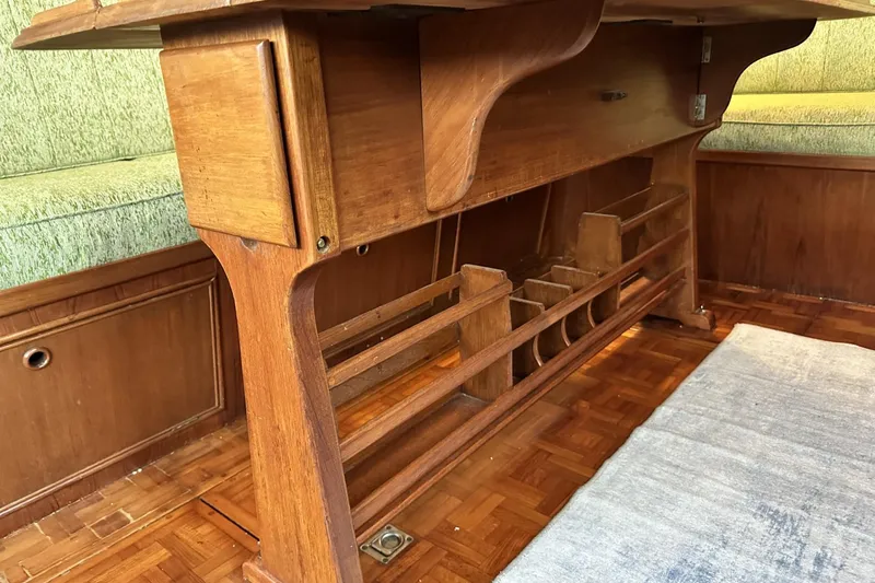 Slide: The Image of Interior of a 1979 Grand Banks 42 Classic yacht, featuring wooden furniture and parquet flooring. - 46