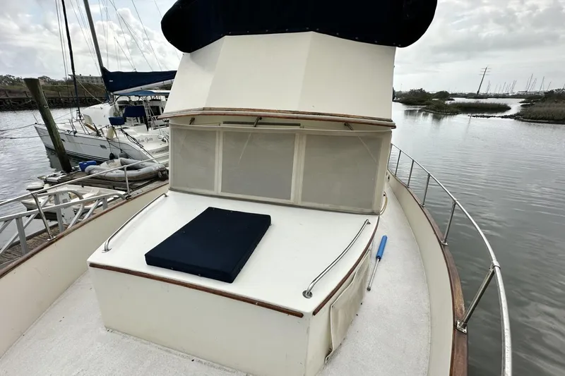 Slide: The Image of 1979 Grand Banks 42 Classic yacht docked by a serene waterway. - 5
