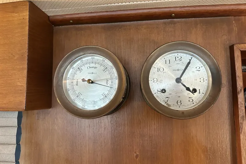 Slide: The Image of Vintage barometer and clock on 1979 Grand Banks 42 Classic yacht interior. - 51