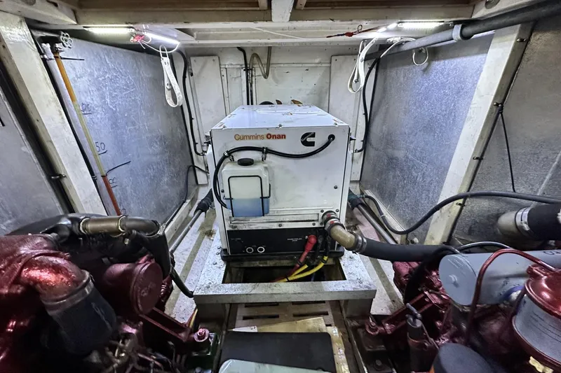Slide: The Image of Engine room of a 1979 Grand Banks 42 Classic with Cummins Onan generator. - 54
