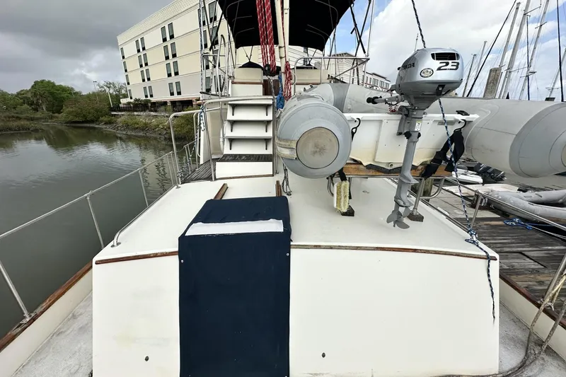 Slide: The Image of 1979 Grand Banks 42 Classic yacht docked, featuring a motor and inflatable boat on deck. - 7