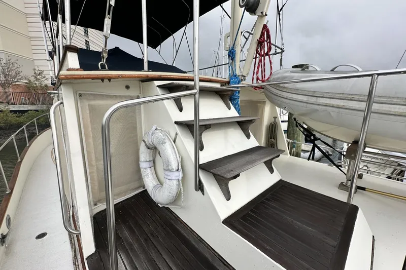 Slide: The Image of 1979 Grand Banks 42 Classic yacht deck with stairs and lifebuoy. - 9