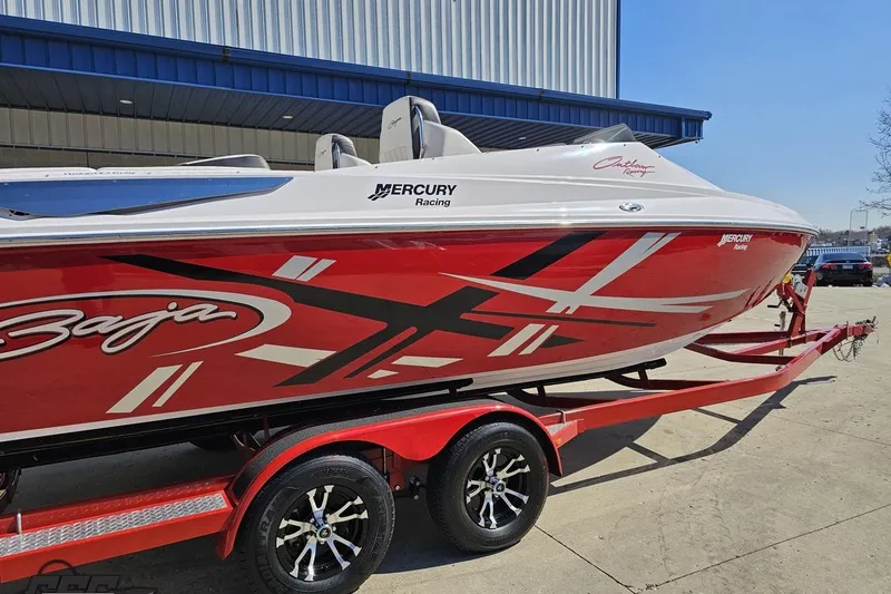 Slide: The Image of 2018 Baja 24 Outlaw speedboat with vibrant red and white design on trailer. - 10