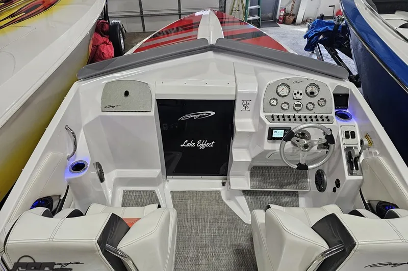 Slide: The Image of Interior of a 2018 Baja 24 Outlaw boat with modern dashboard and seating. - 102