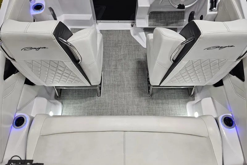 Slide: The Image of Interior of 2018 Baja 24 Outlaw boat with white leather seats and blue LED cup holders. - 103