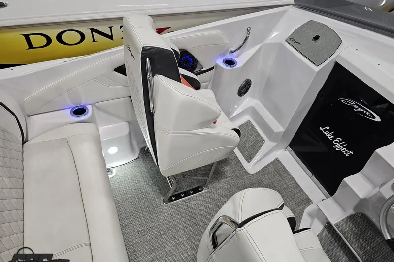 Slide: The Image of Interior of a 2018 Baja 24 Outlaw boat with white seating and blue LED cup holders. - 105