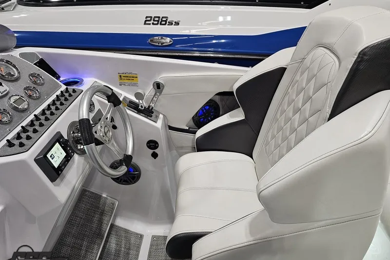 Slide: The Image of 2018 Baja 24 Outlaw boat cockpit with steering wheel and plush seating. - 109