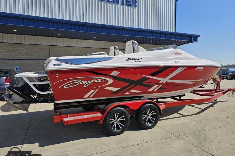 Slide: The Image of 2018 Baja 24 Outlaw speedboat with red and white design on a trailer. - 11