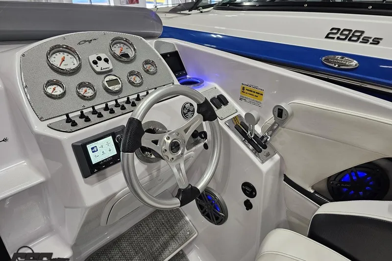 Slide: The Image of Cockpit of a 2018 Baja 24 Outlaw boat with steering wheel and control panel. - 110